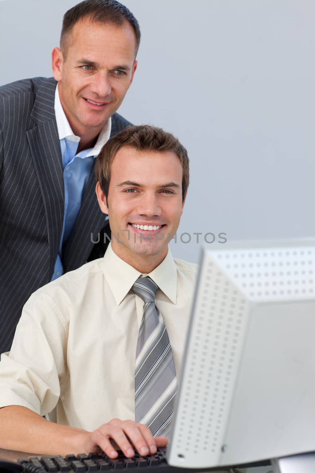 Confident business partners working together at a computer by Wavebreakmedia