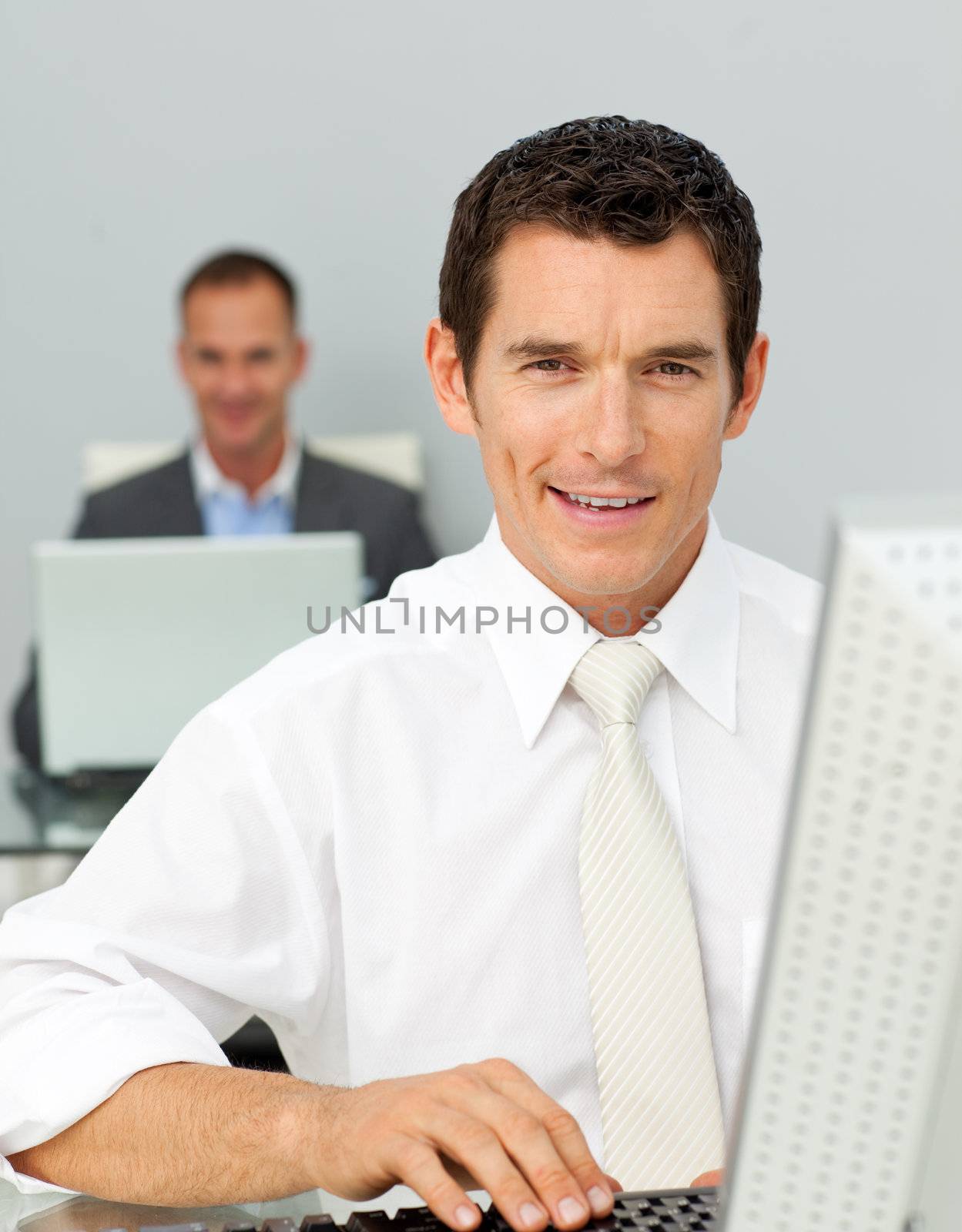 Confident businessman working at his computer in the office