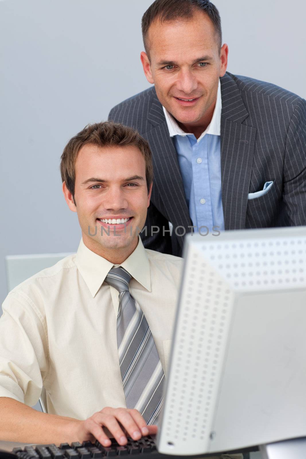 Attractive manager checking his employee's work in the office