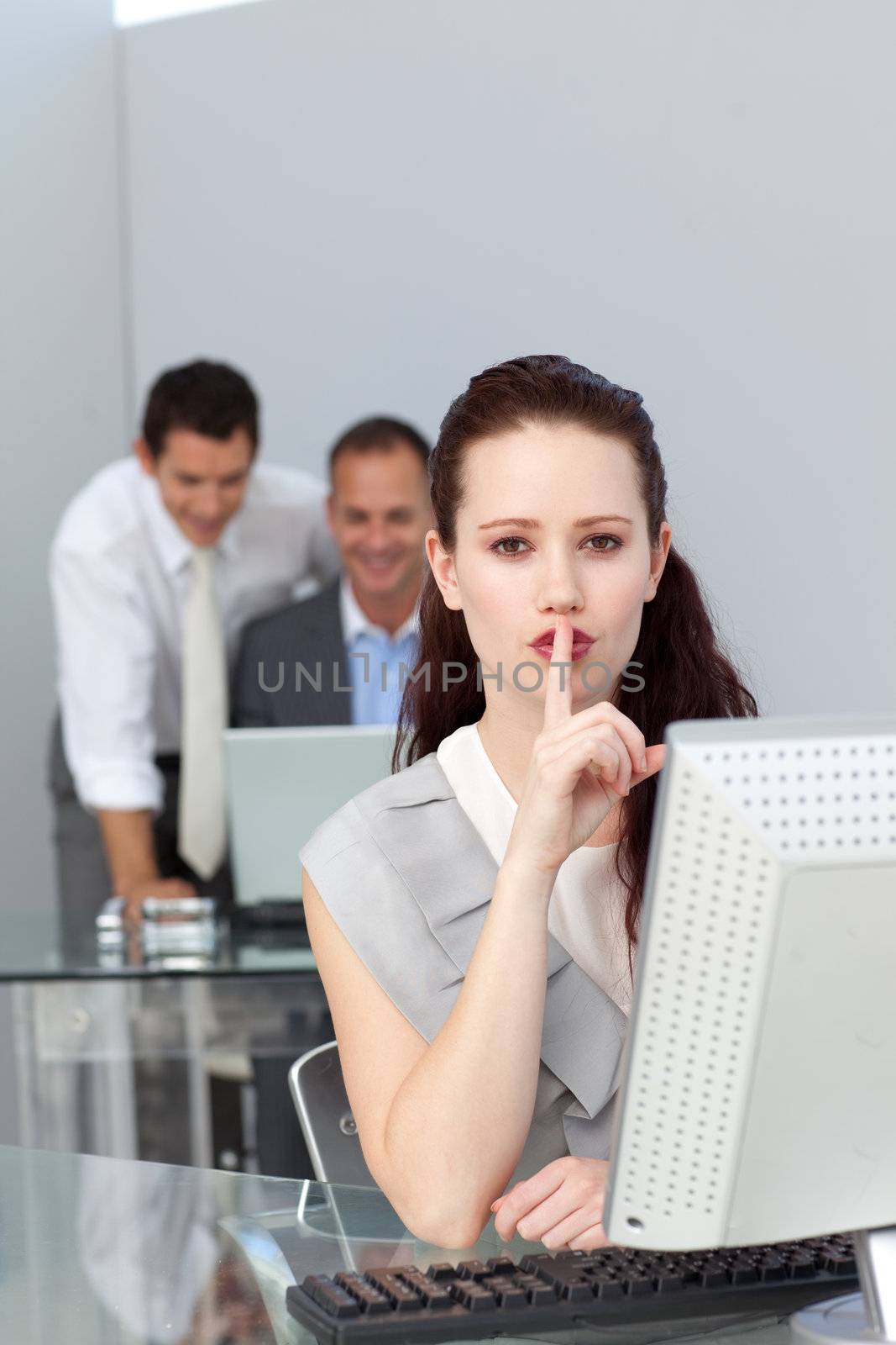Charming businesswoman asking for silence in the office