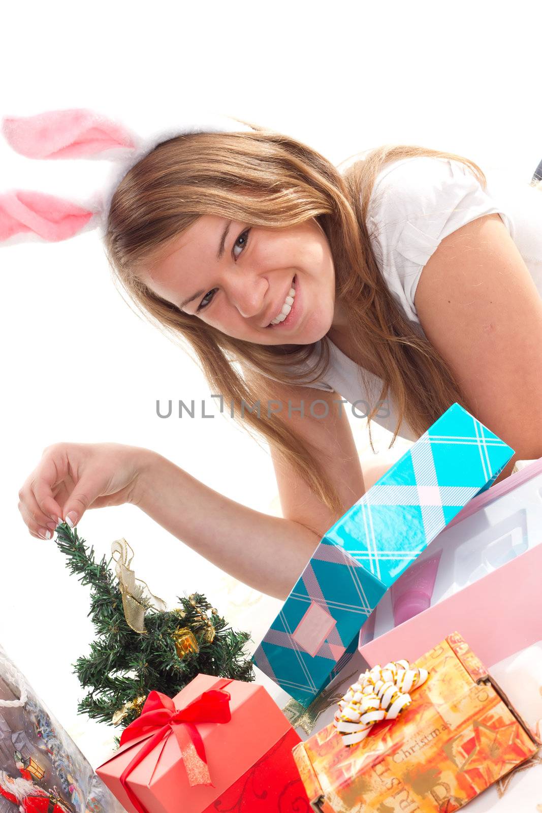 girl lying beside Christmas presents studio shooting