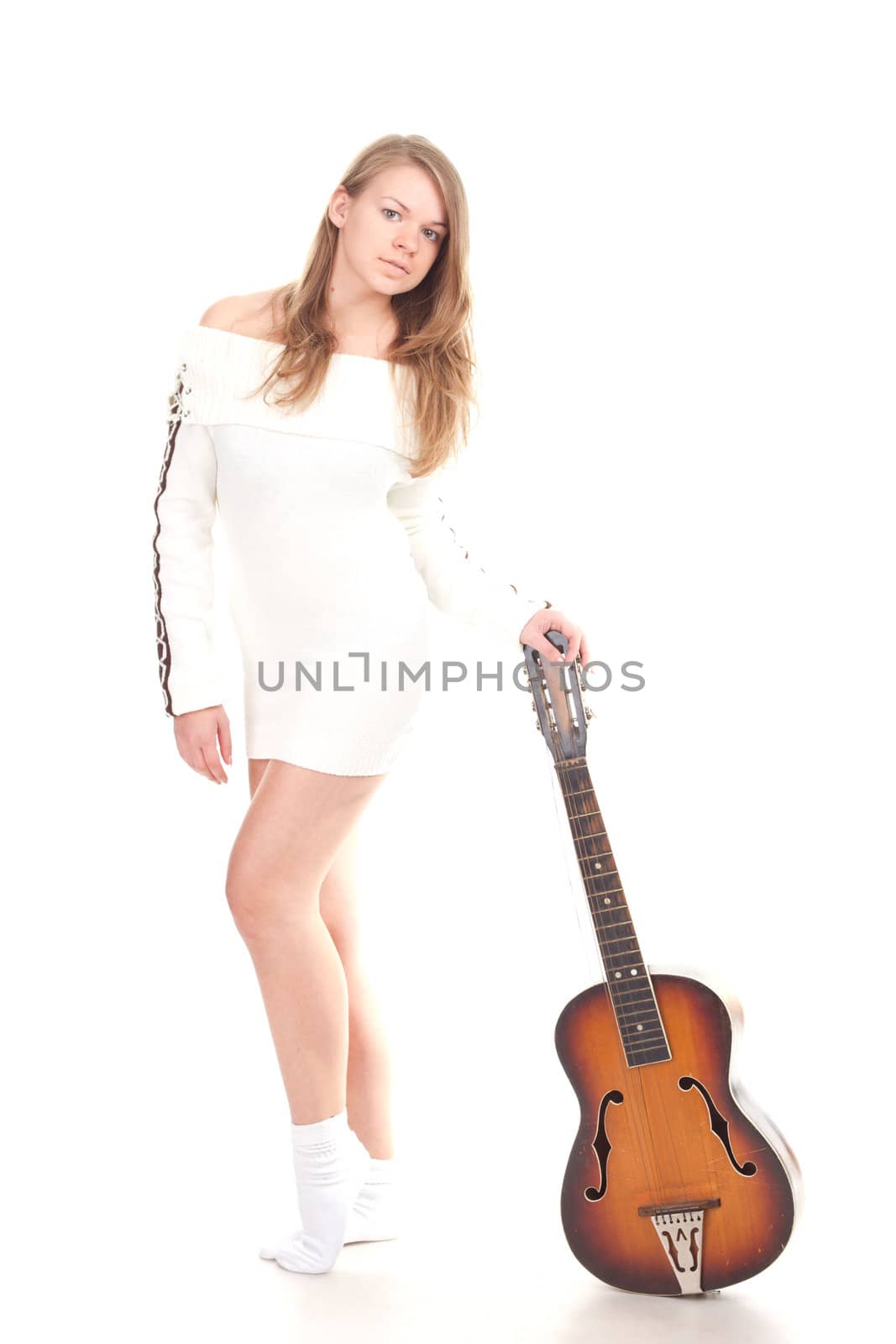 Beautiful girl in sweater with a guitar studio photography