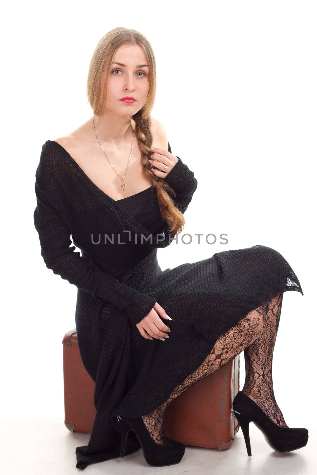 woman is sitting on old leather case studio shoot