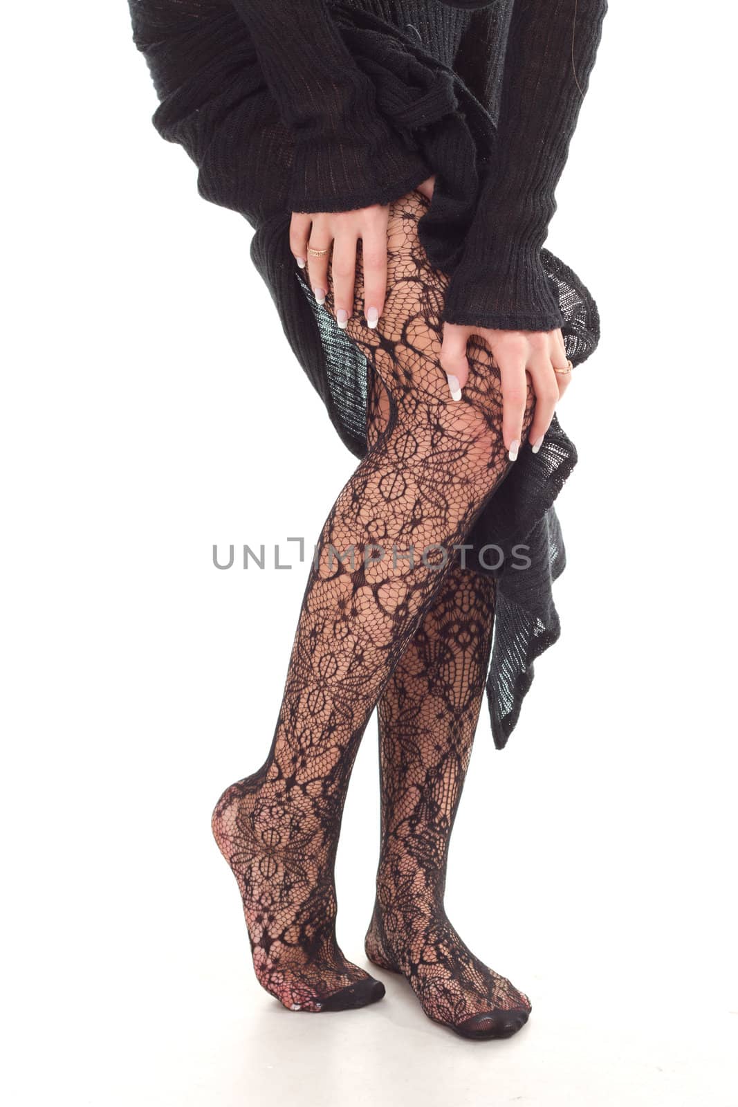 Beautiful woman legs in black stockings studio shoot