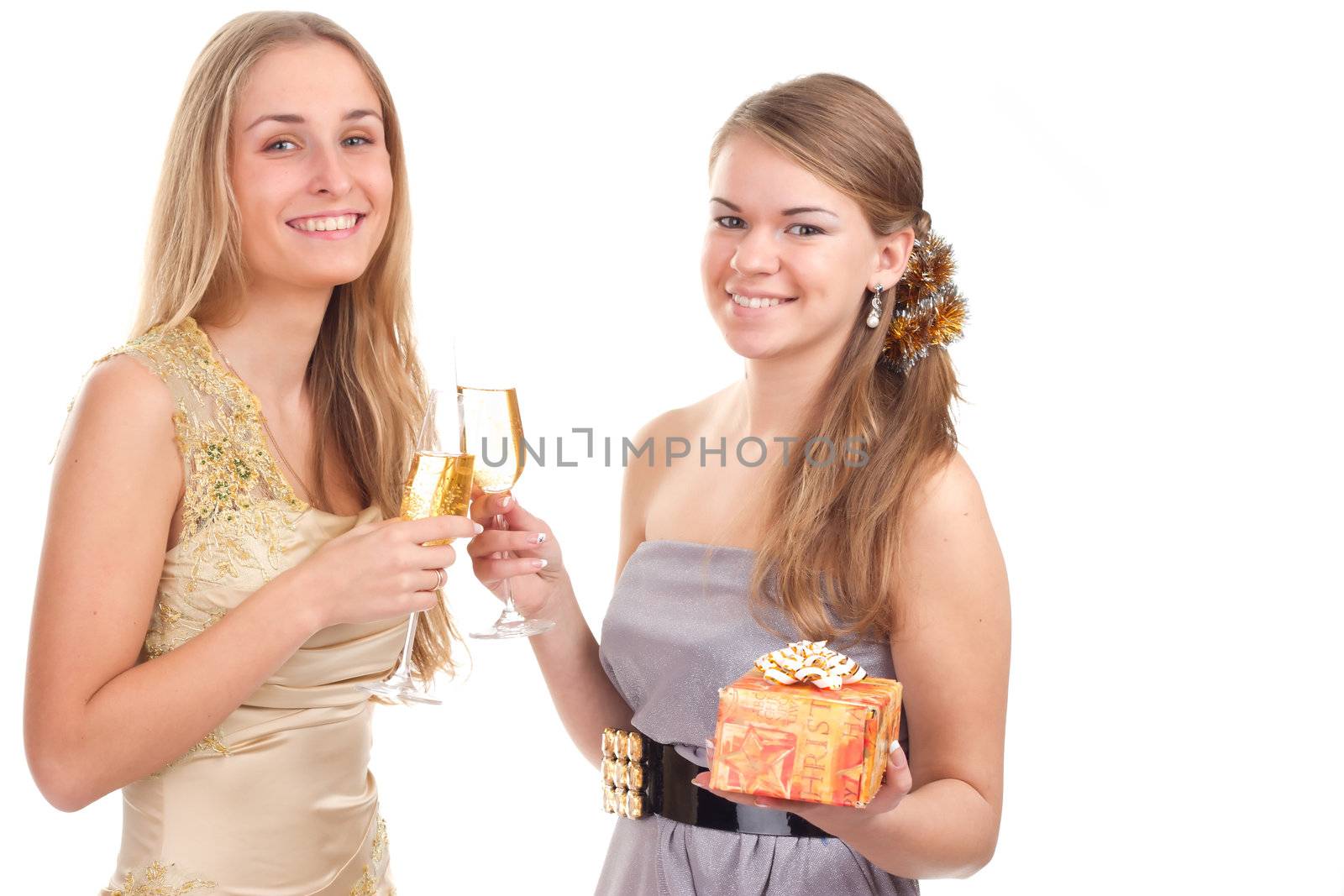 Two girls celebrate Christmas with gifts and glasses in their hands studio shooting