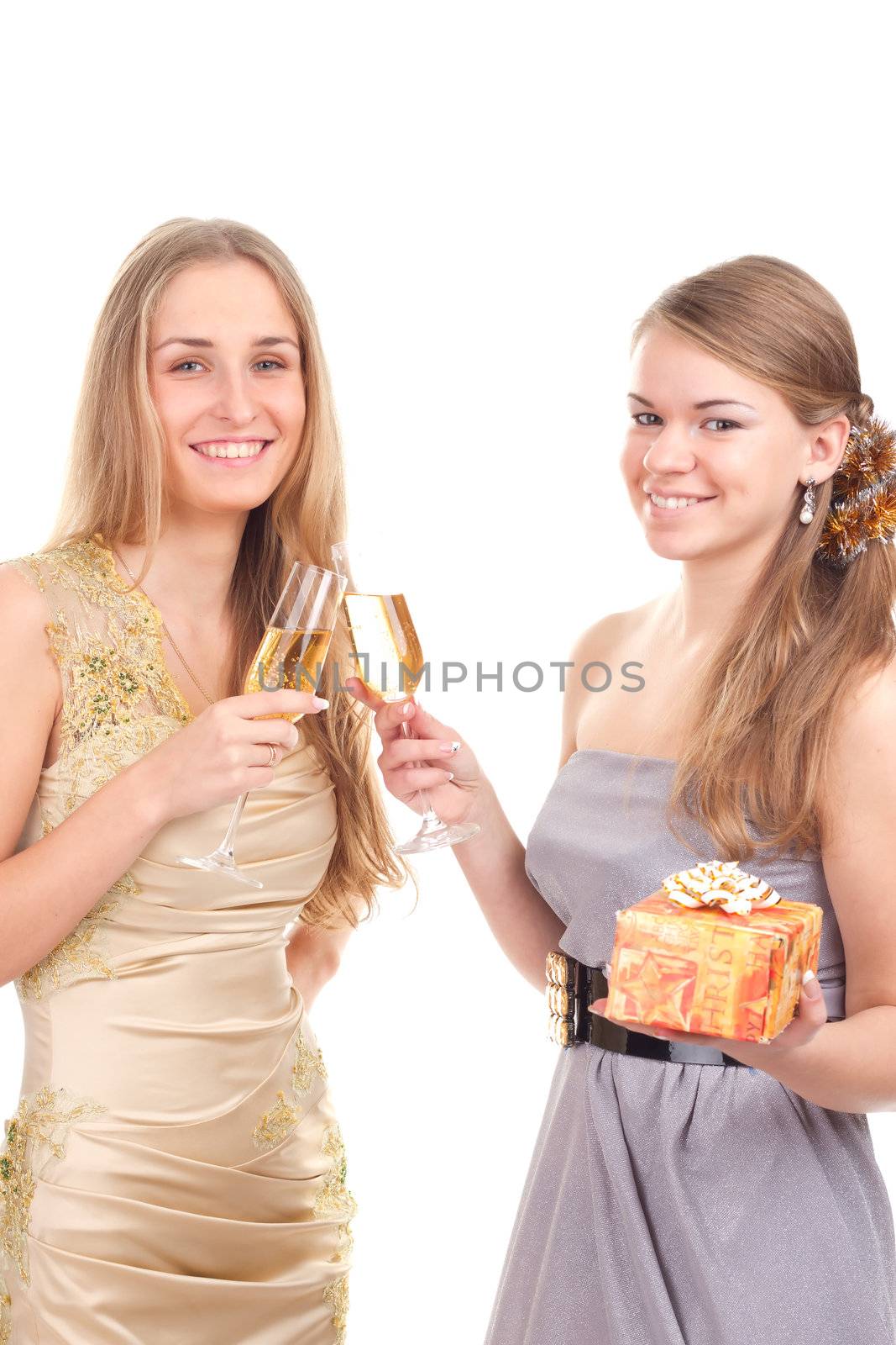 Two girls celebrate Christmas with gifts and glasses in their hands studio shooting