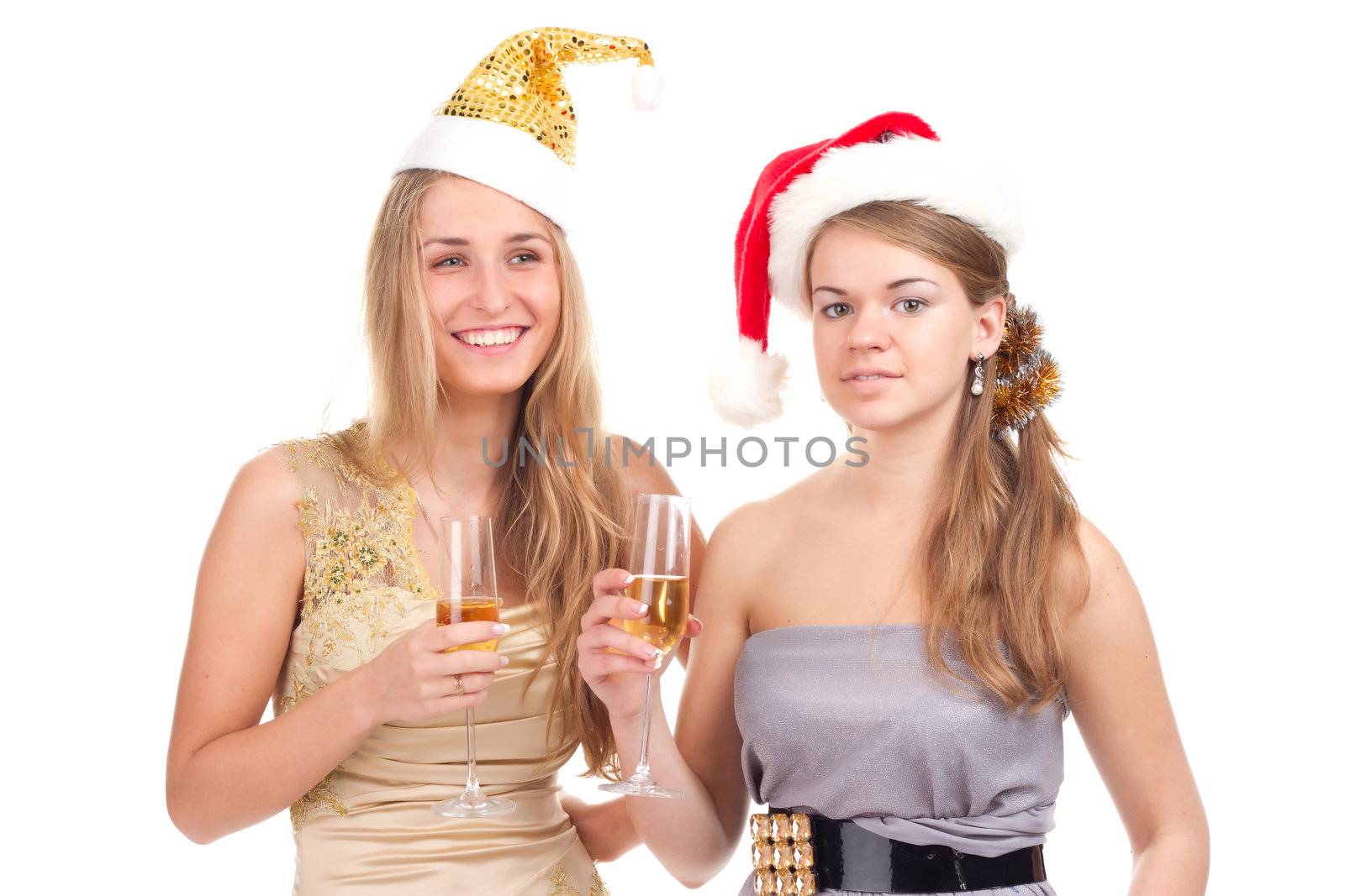 Two girls celebrate Christmas with gifts and glasses in their hands studio shooting