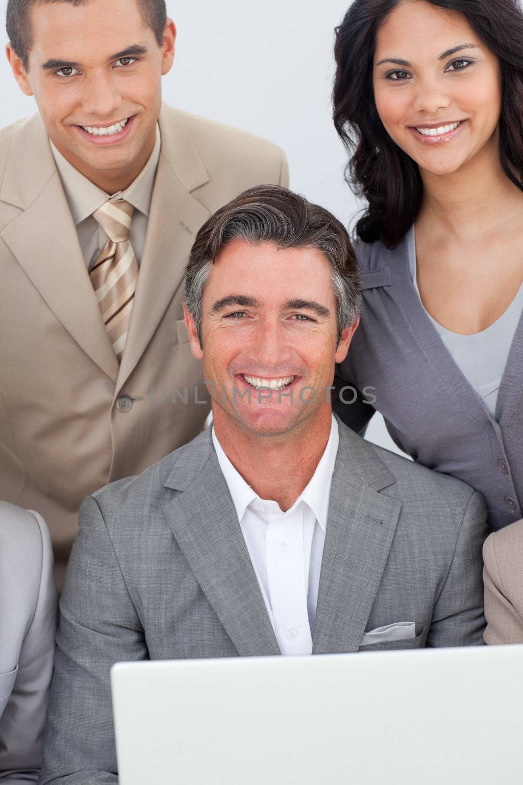 Multi-ethnic business team working with a laptop in office together