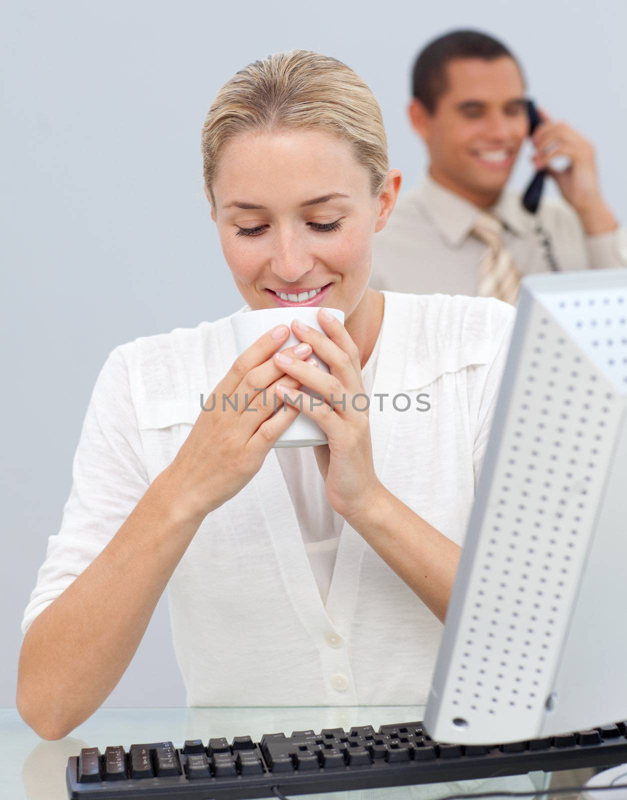 Attractive woman drinking a coffee during the break in the office