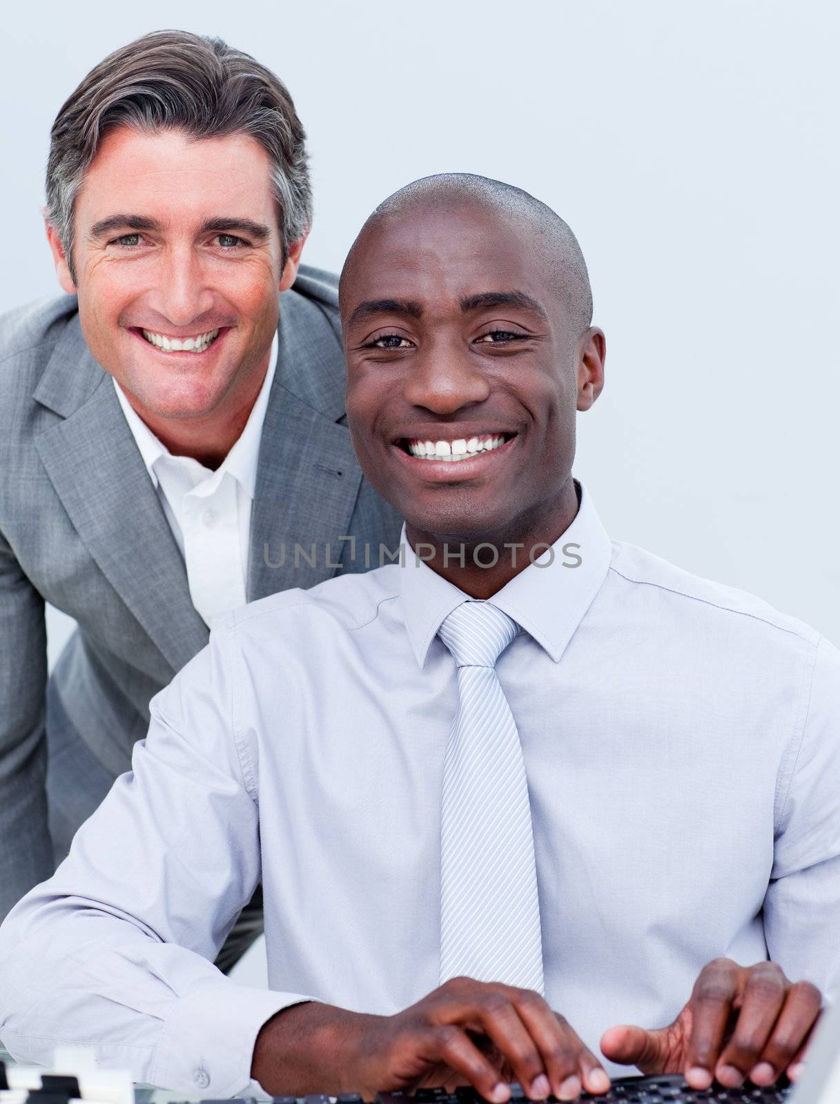 Smiling mature businessman helping his colleague in the office