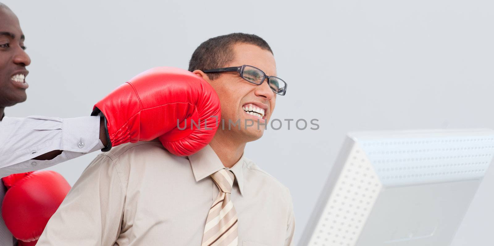 Young businessman being boxed in the office while he is working