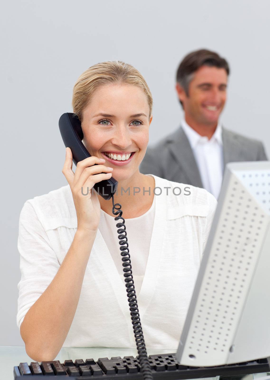 Smiling businesswoman talking on phone in the office