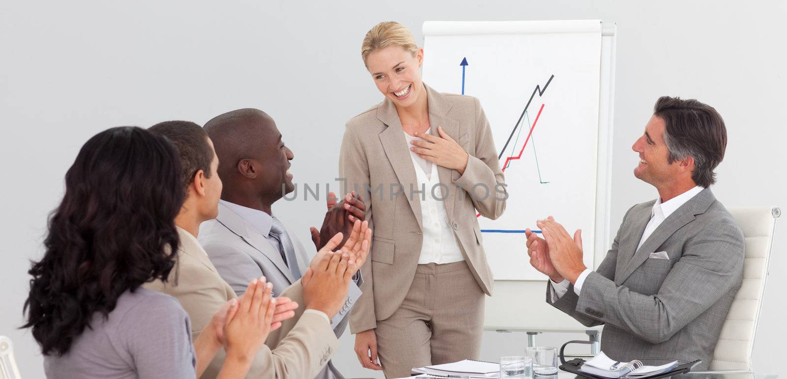 Businesswoman standing smilling after a presentation by Wavebreakmedia