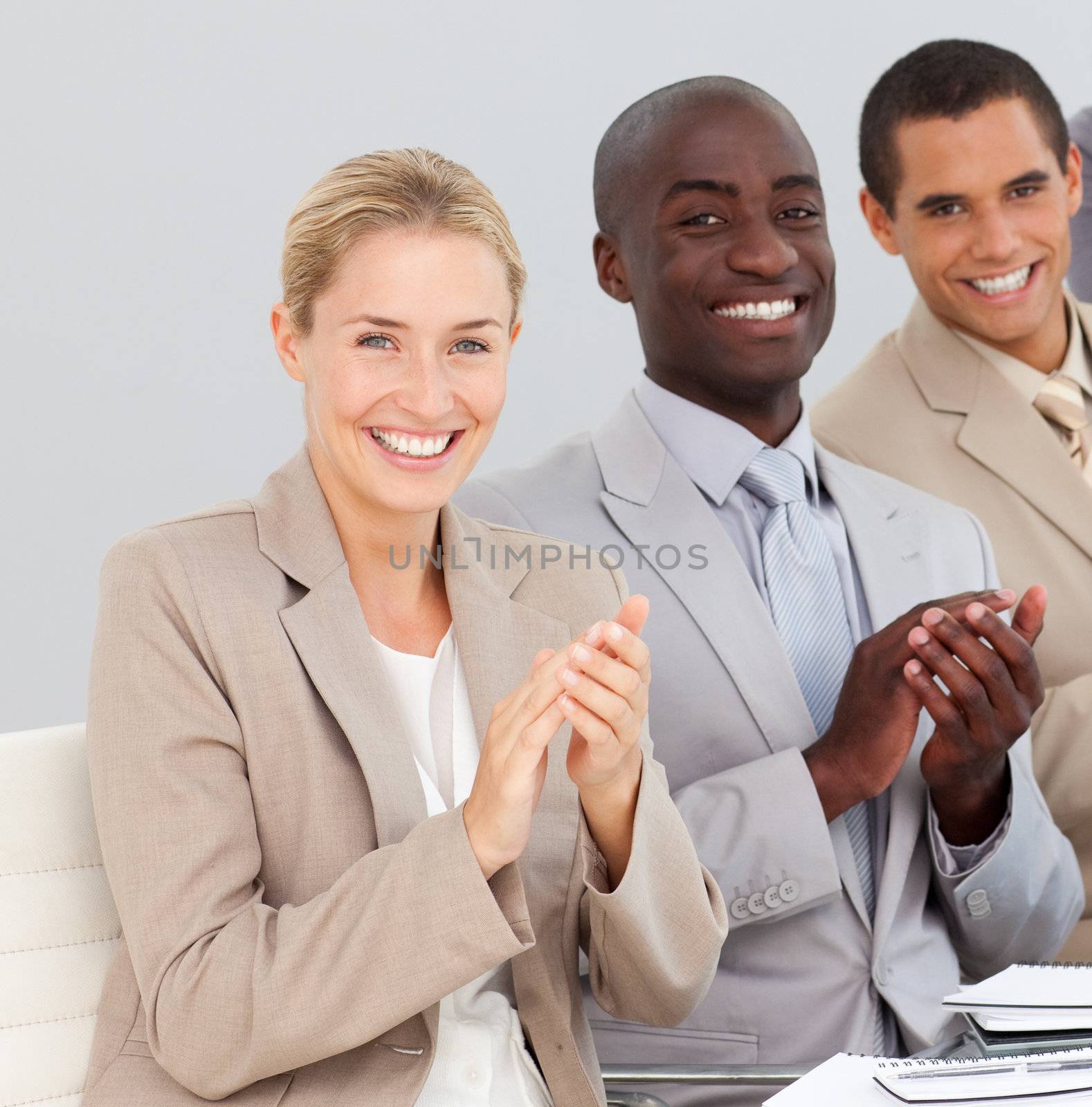 Young Business team in a meeting clapping at a presentation