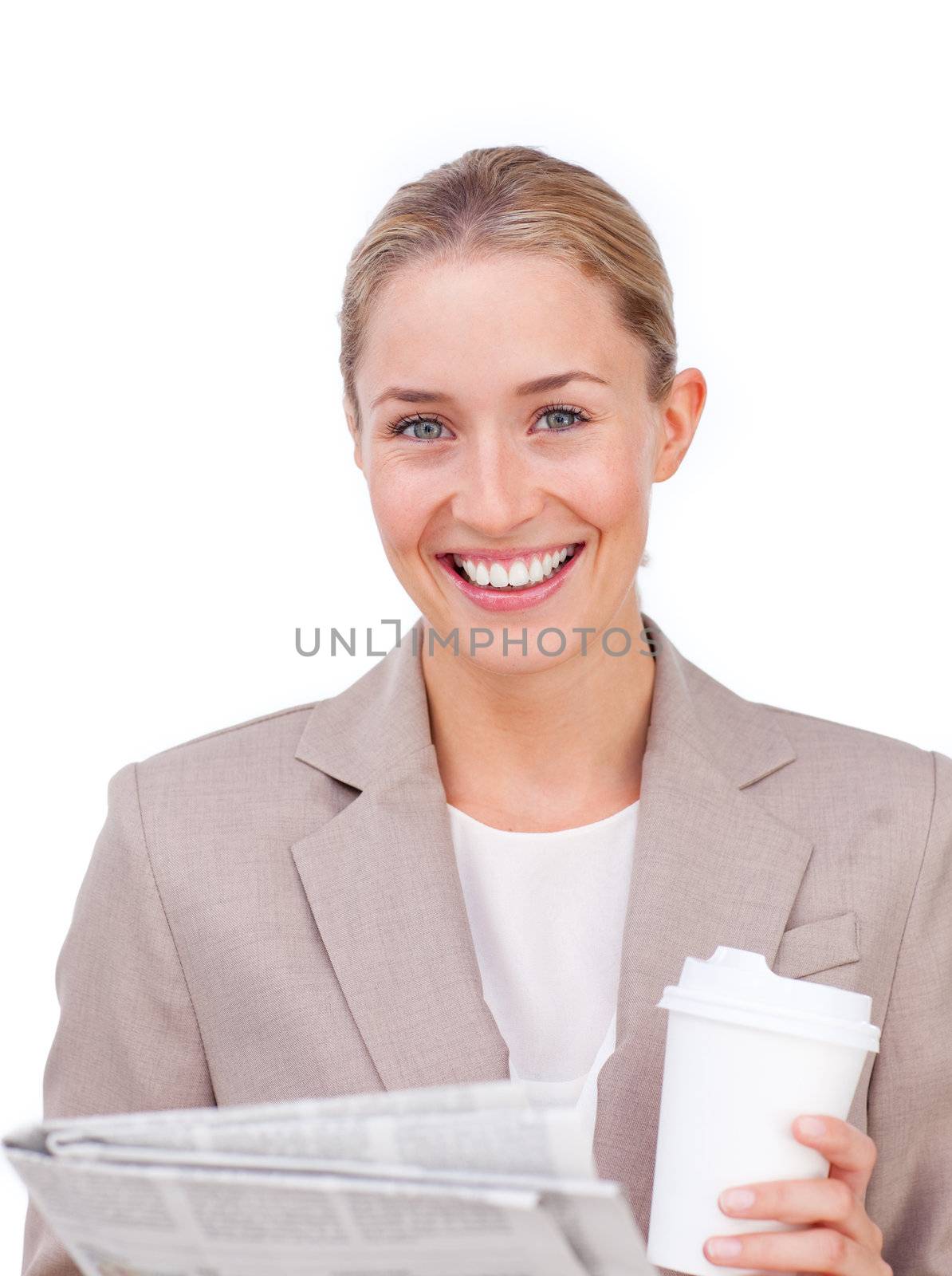Businesswoman reading a newspaper while drinking a coffee by Wavebreakmedia