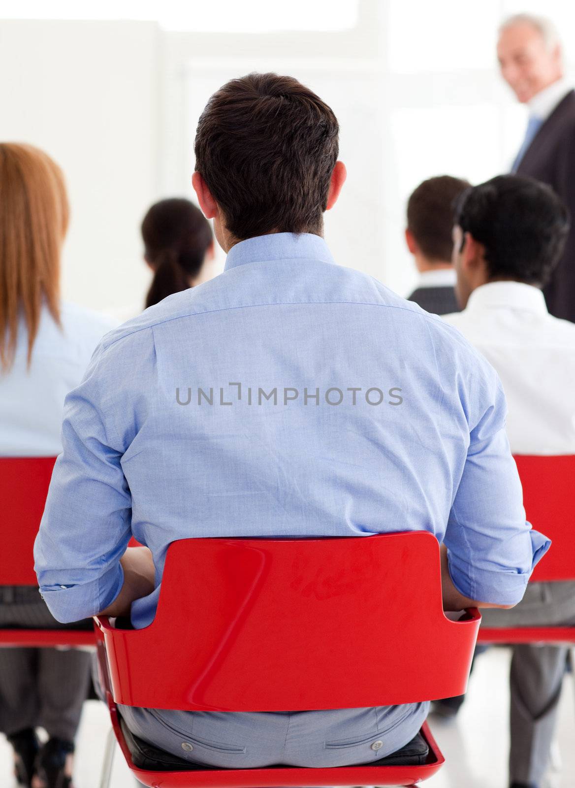 Businessman from behind at a conference in the office