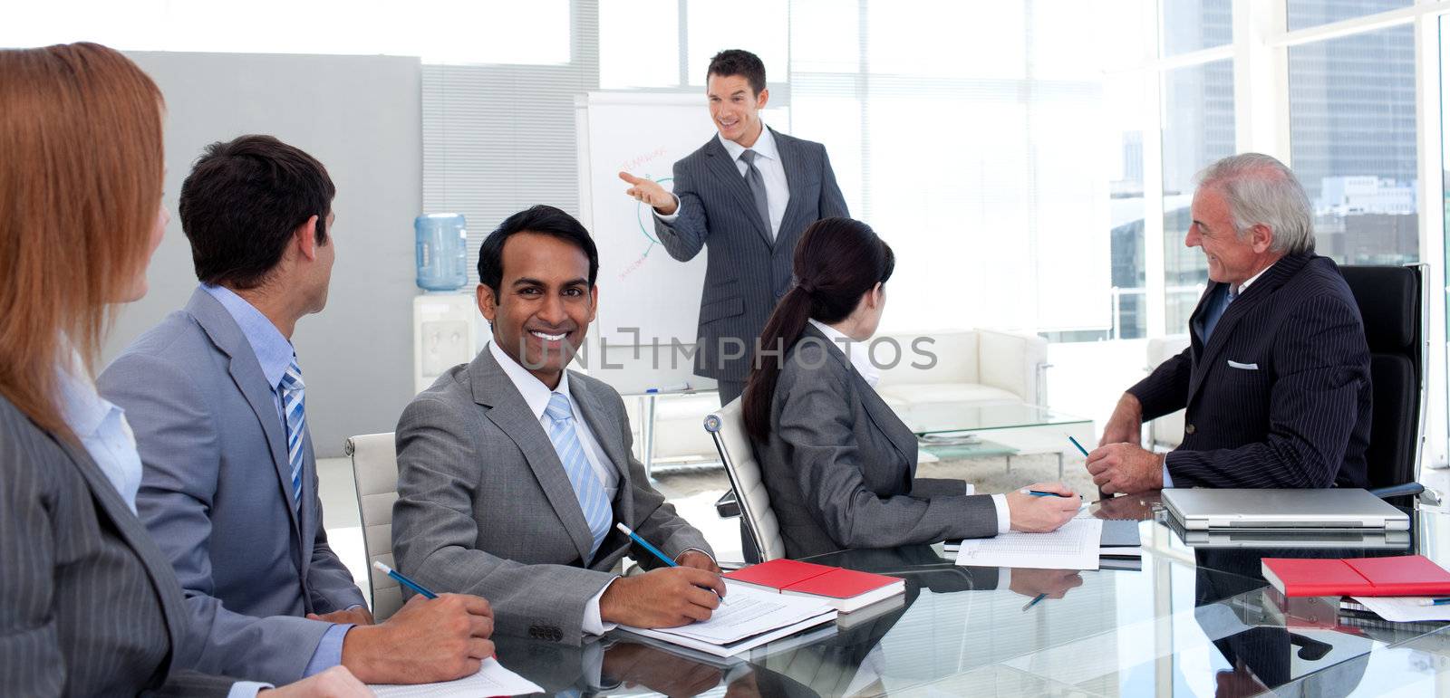 Businessman reporting sales figures to his team by Wavebreakmedia