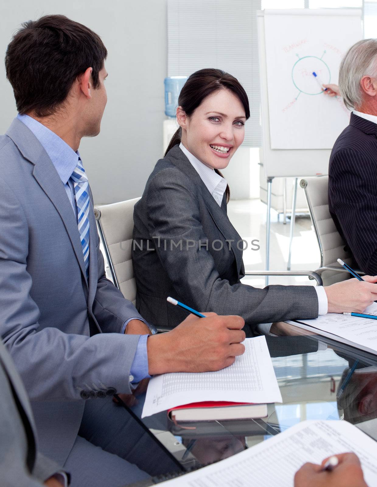 Young businesswoman smiling at the camera in a meeting