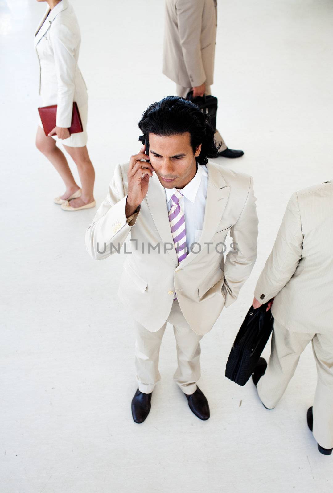 Attractive businessman on phone in a business building by Wavebreakmedia