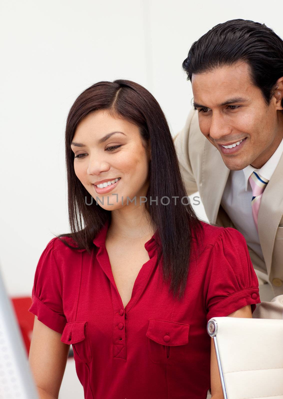 Happy business people working at a computer in the office