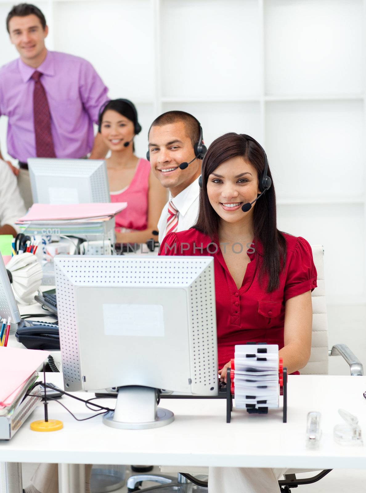 Smiling business people with headset on working in the office