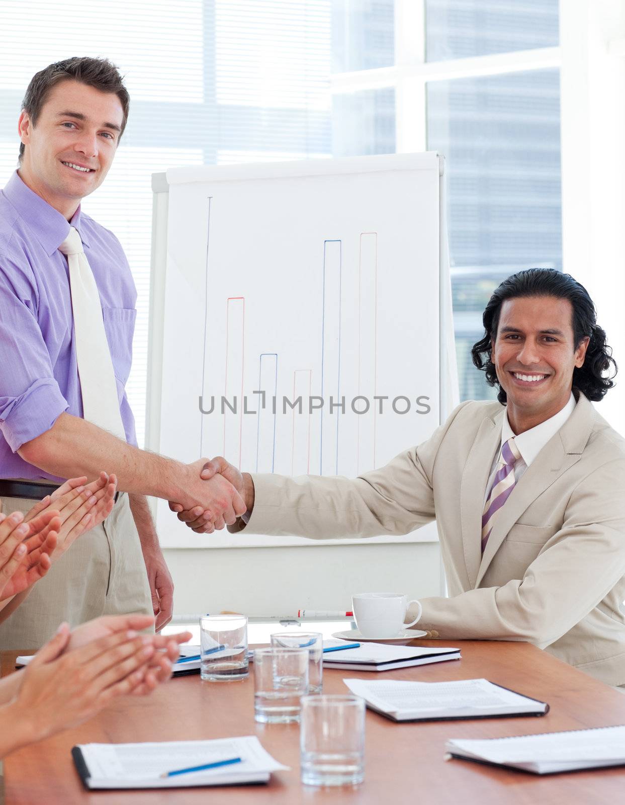 Two businessmen having a handshake in a company