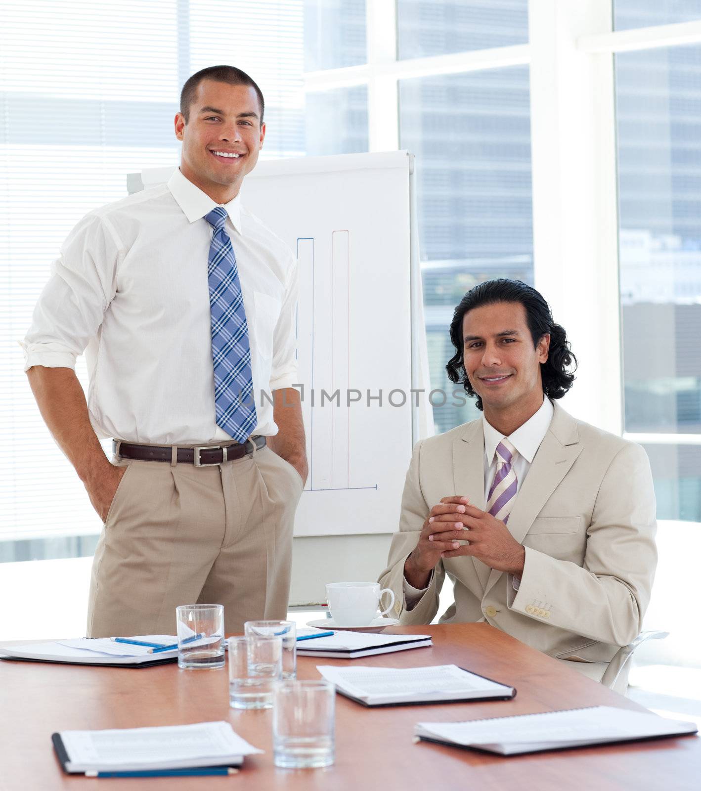 Smiling businessman giving a presentation in a company