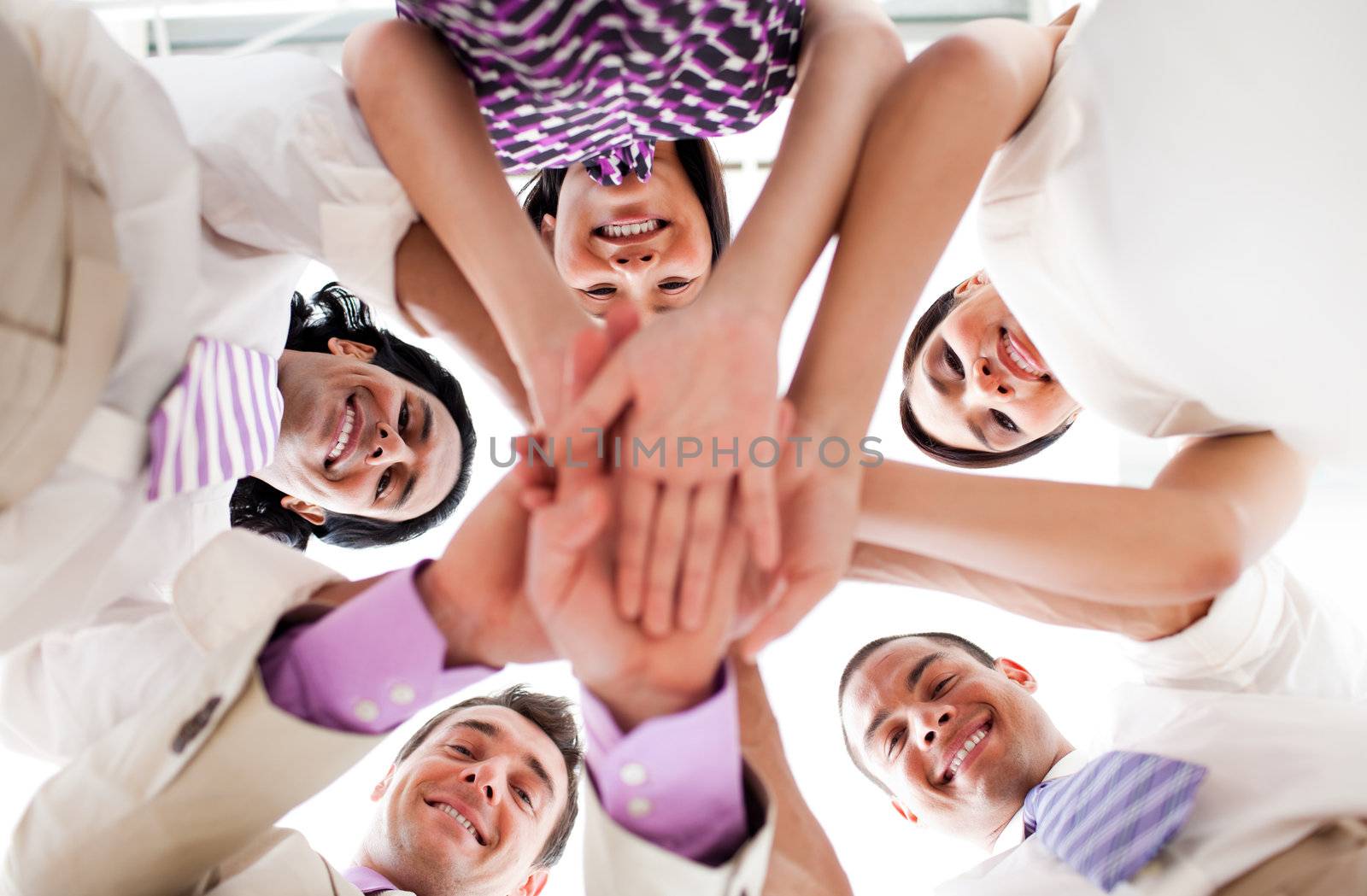 Smiling business people holding hands together in a circle  by Wavebreakmedia