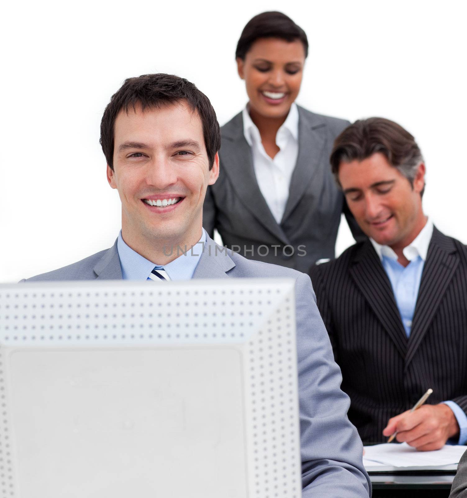 Portrait of a businessman and his team working at a computer in the office