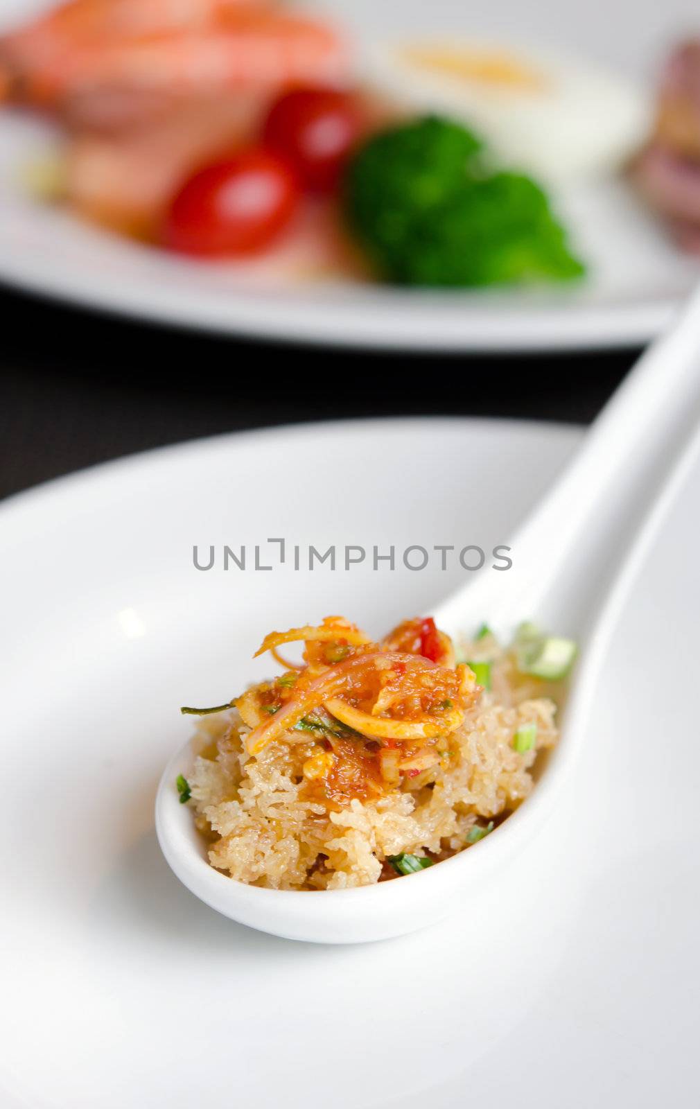 crispy fried rice noodle with sweet and sour sauce in spoon , Thai cuisine