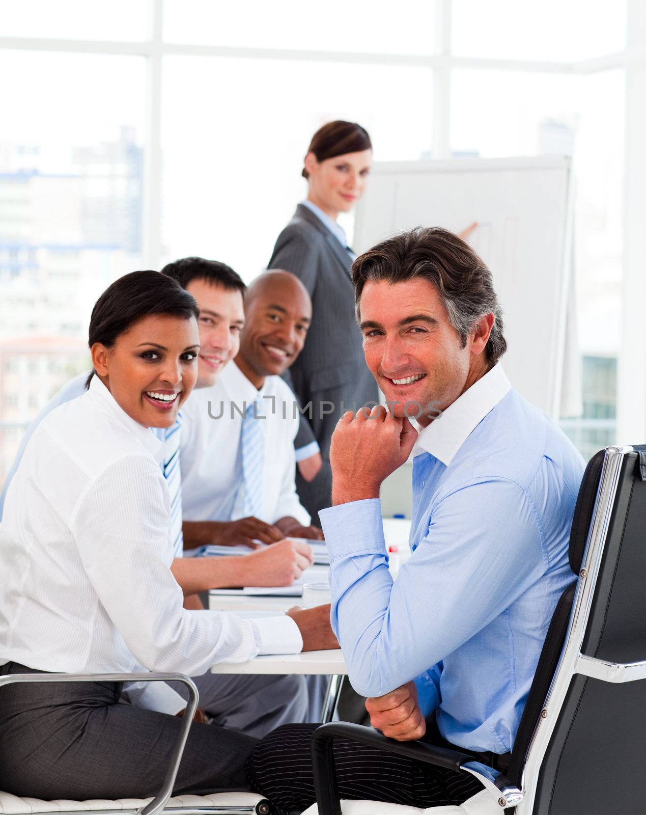 Multi-ethnic business team at a meeting smiling at the camera