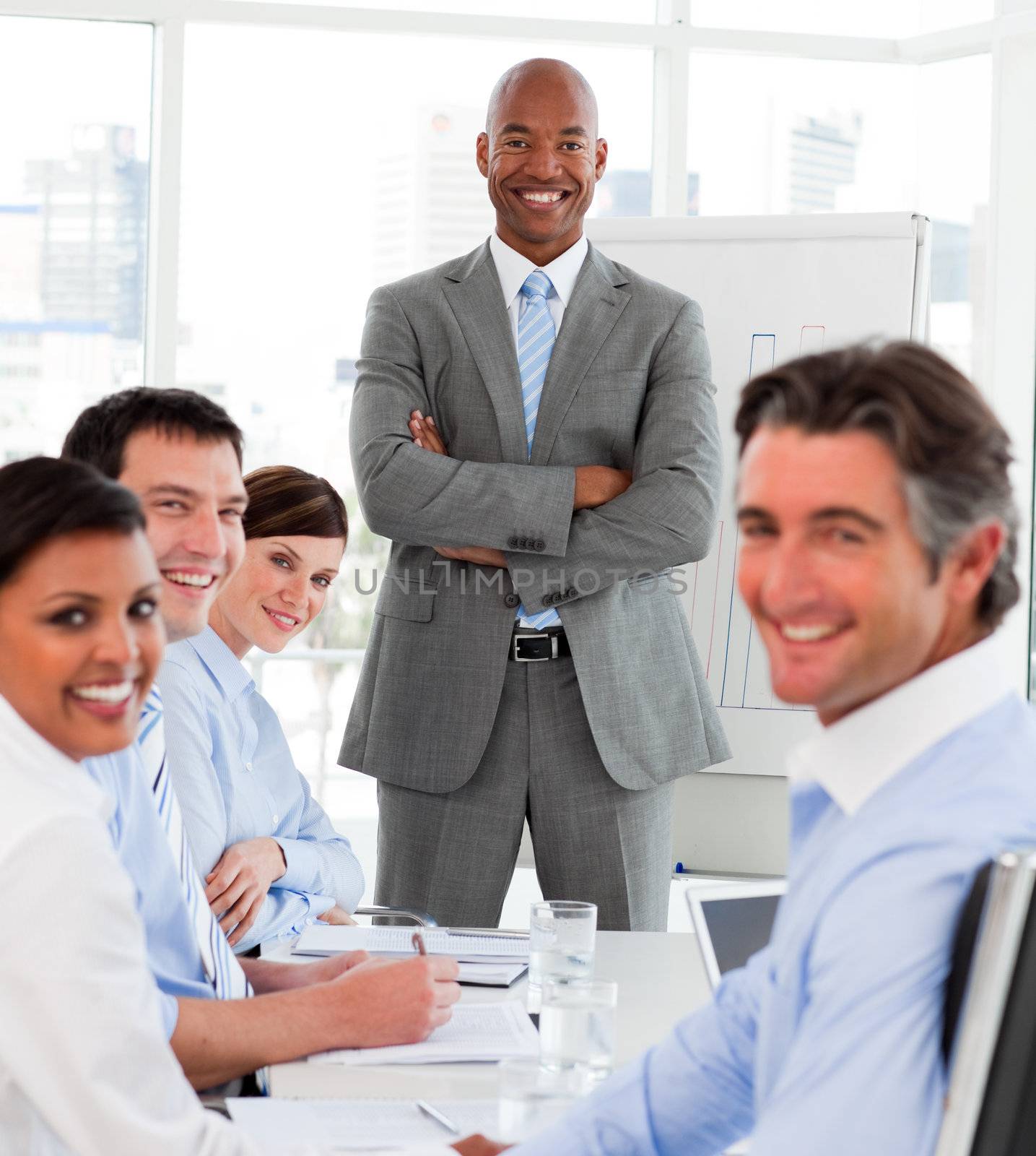 Afro-american businessman giving a presentation to his team in the office