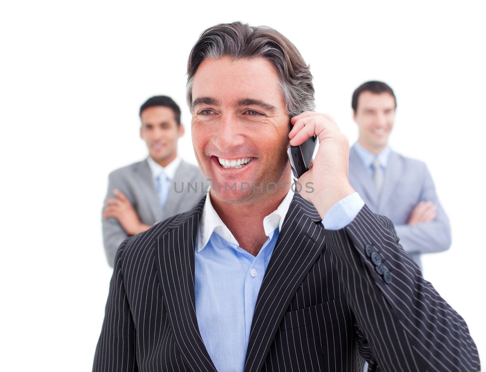 Charismatic businessman talking on phone against a white background