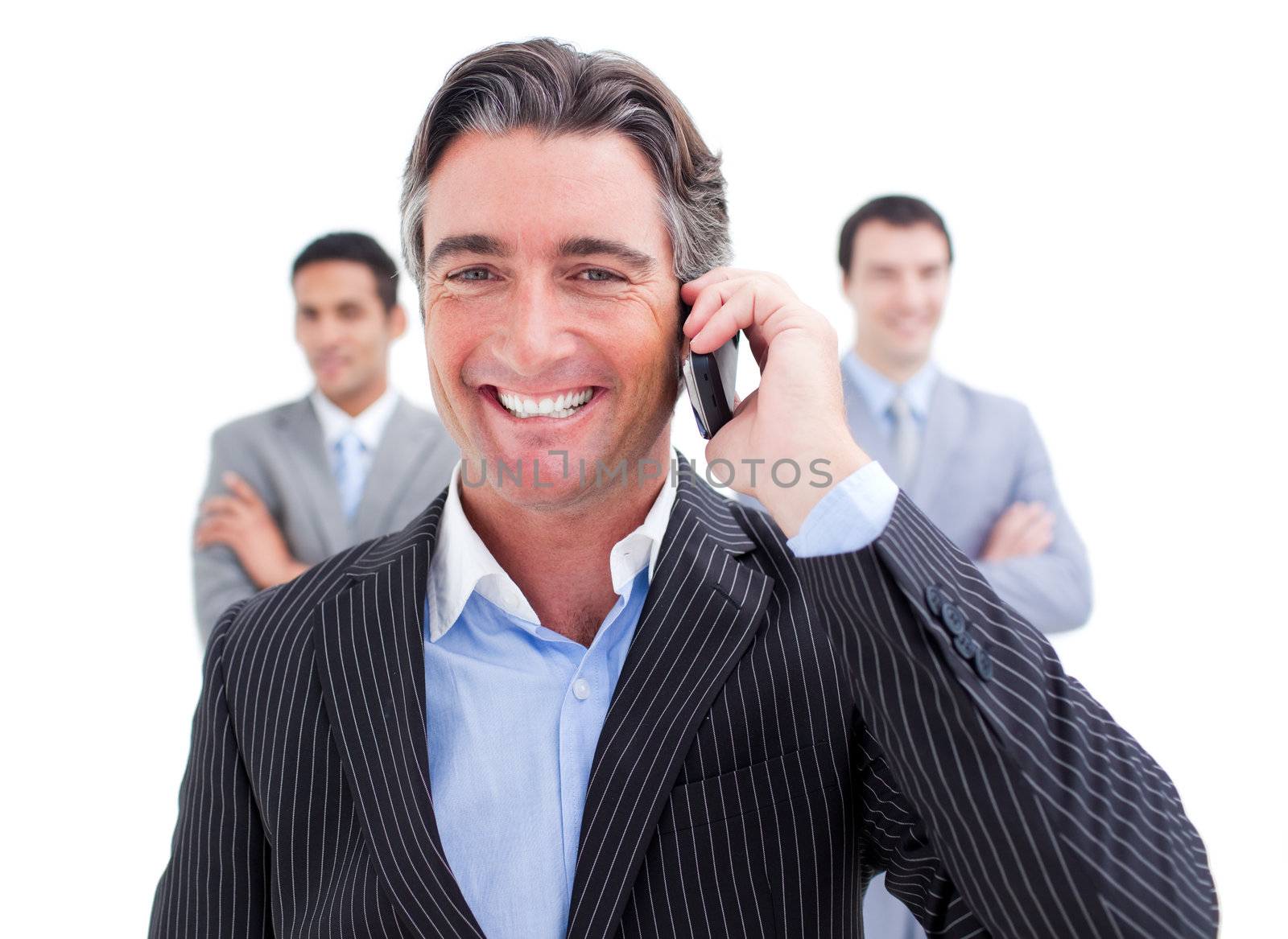 Laughing businessman talking on phone against a white background