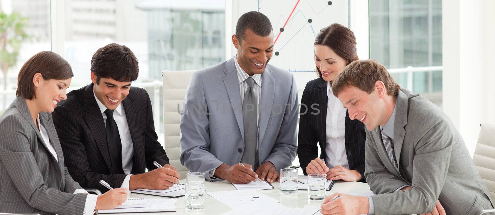 A diverse business group studying a budget plan in a meeting