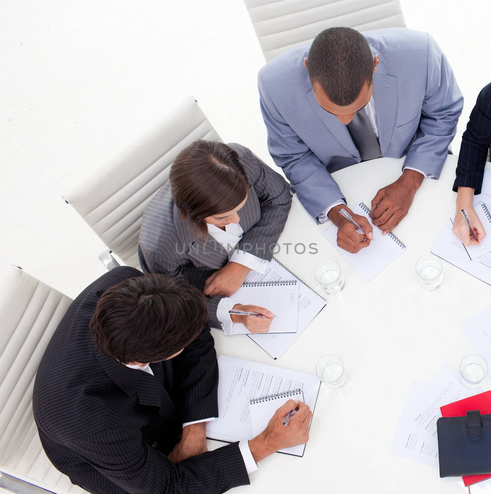 High angle of an international young business people discussing a new strategy in the office