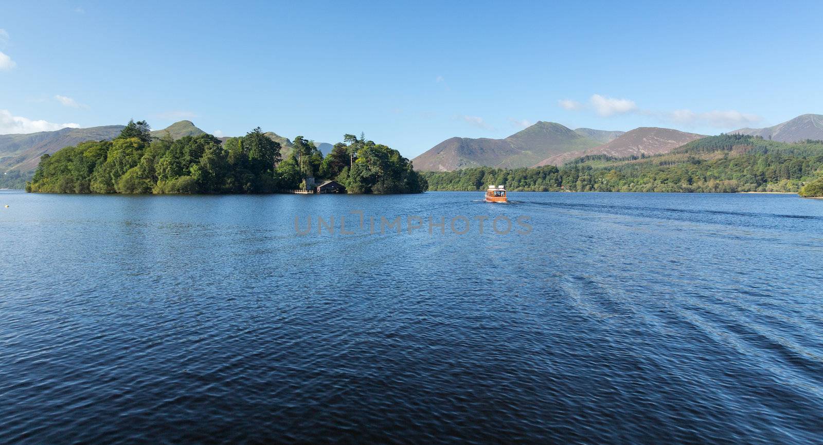 Piers and boats on edge of Derwentwater in English Lake District in early morning