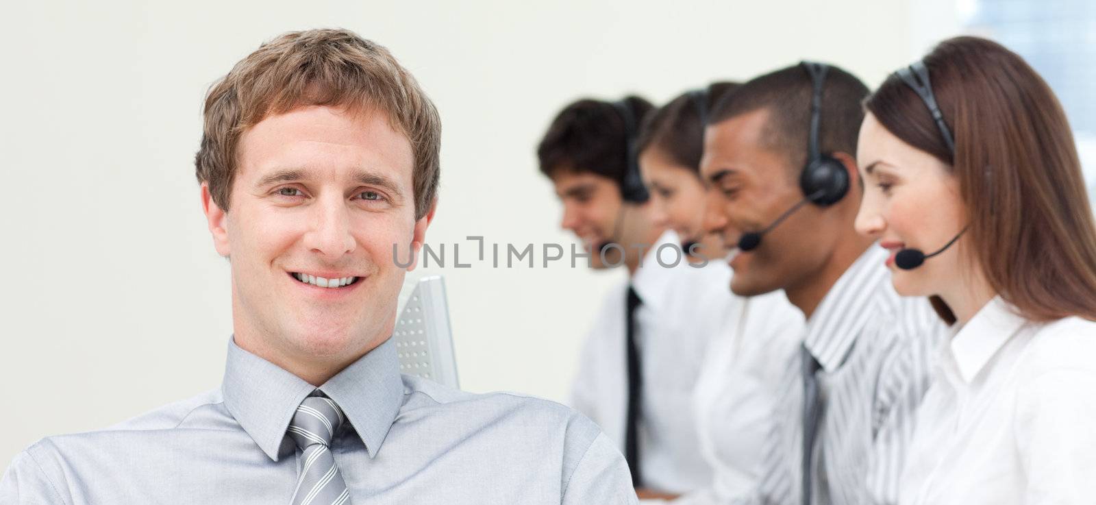 Young manager with his team in a call center by Wavebreakmedia