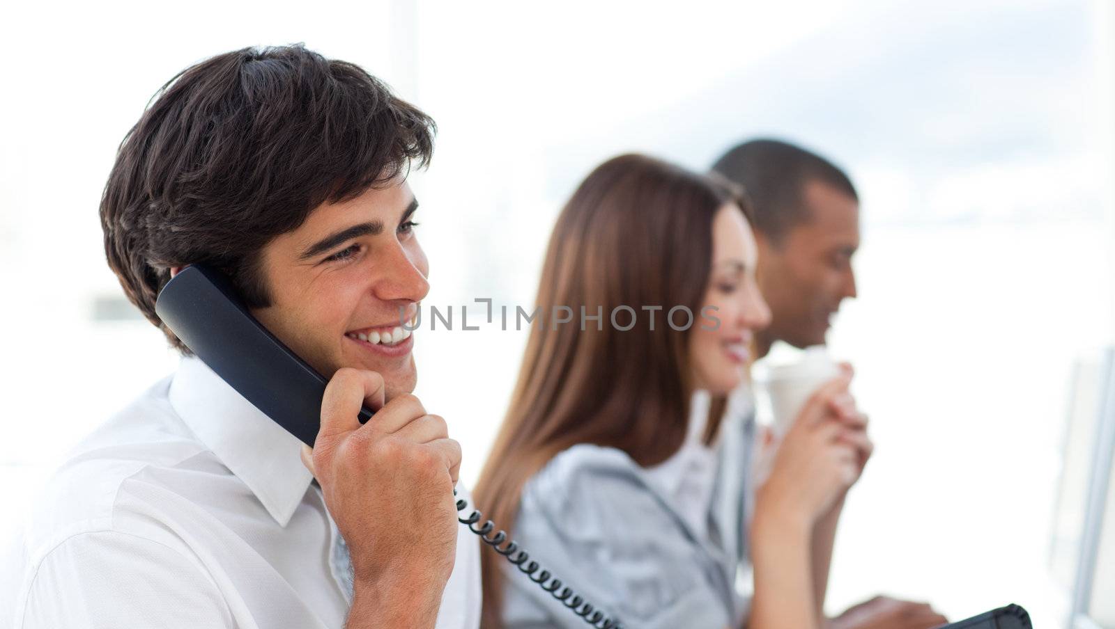 Assertive businessman talking on phone by Wavebreakmedia