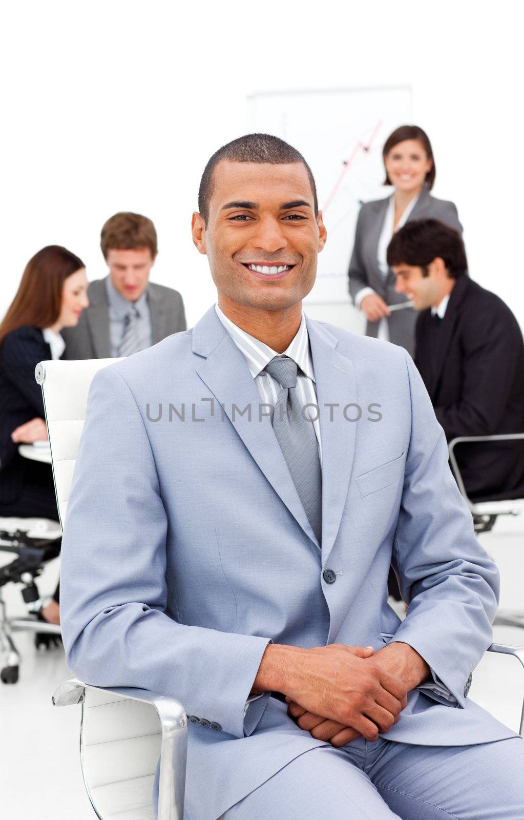 Afro-american businessman sitting in front of his colleagues in a meeting