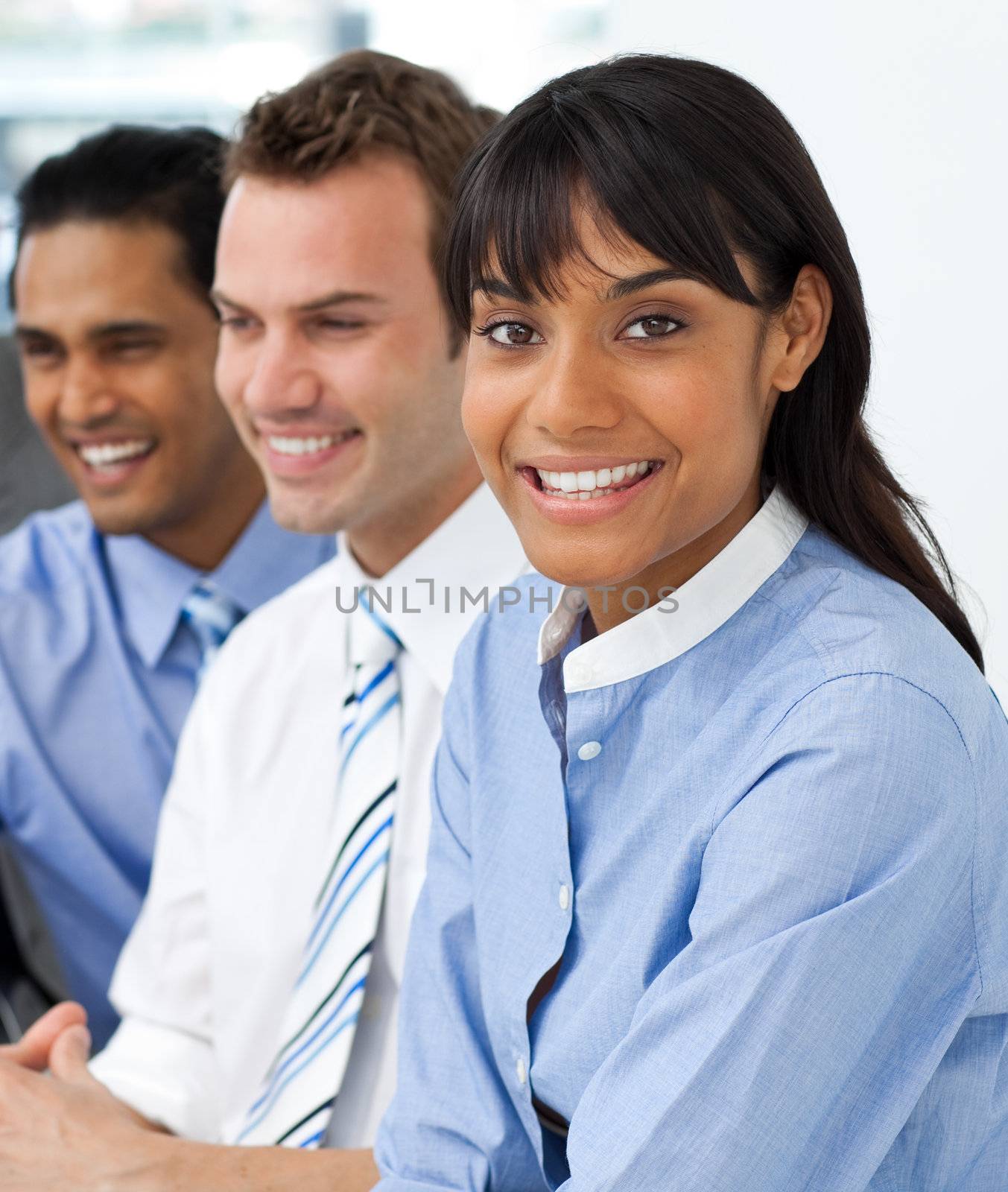 Multi-ethnic young business team sitting in a row in the office