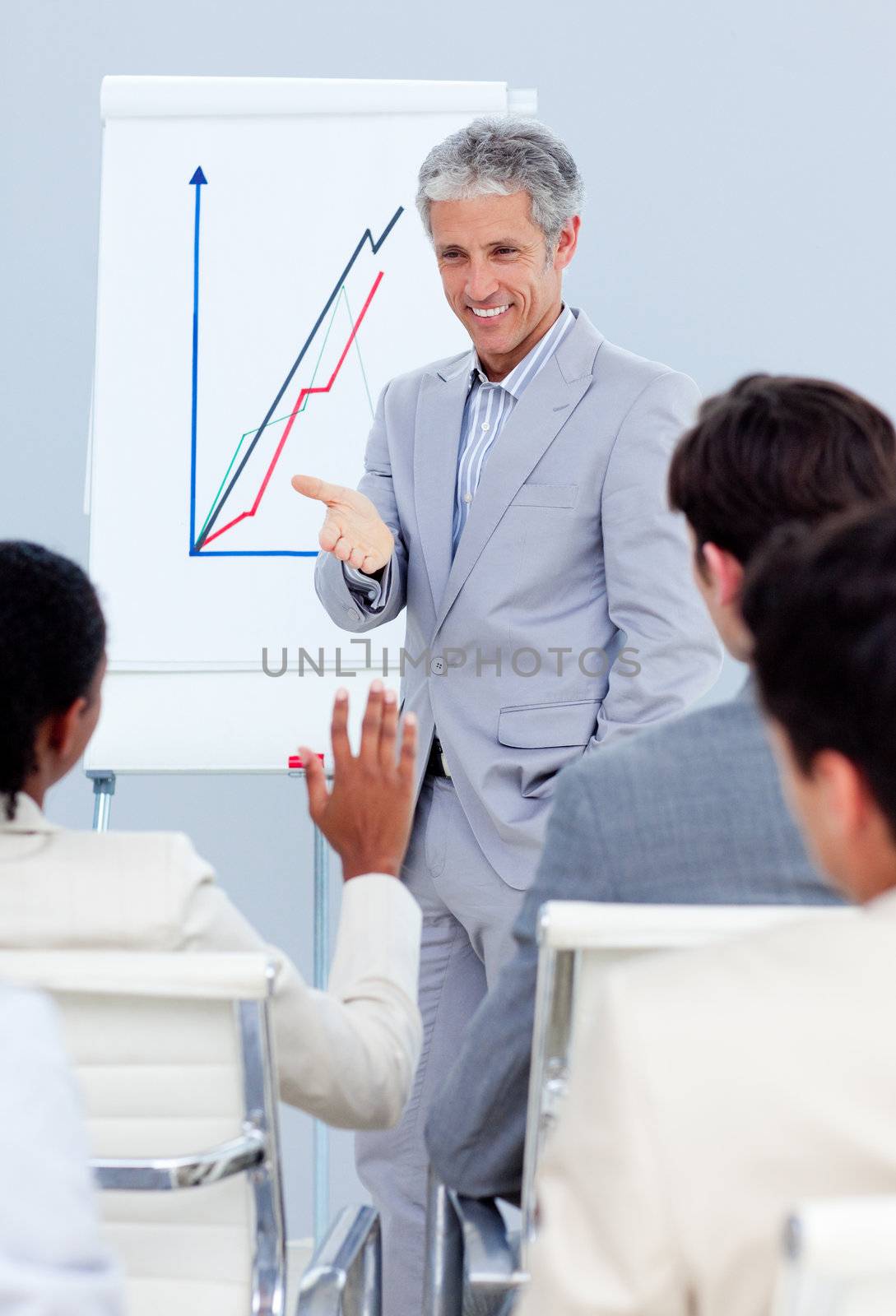 Charming businessman doing a presentation to his colleagues