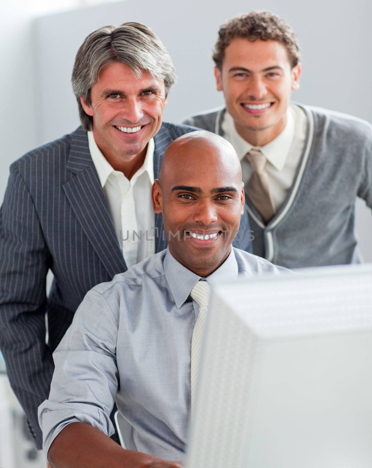 Self-assured business partners working at a computer together in the office