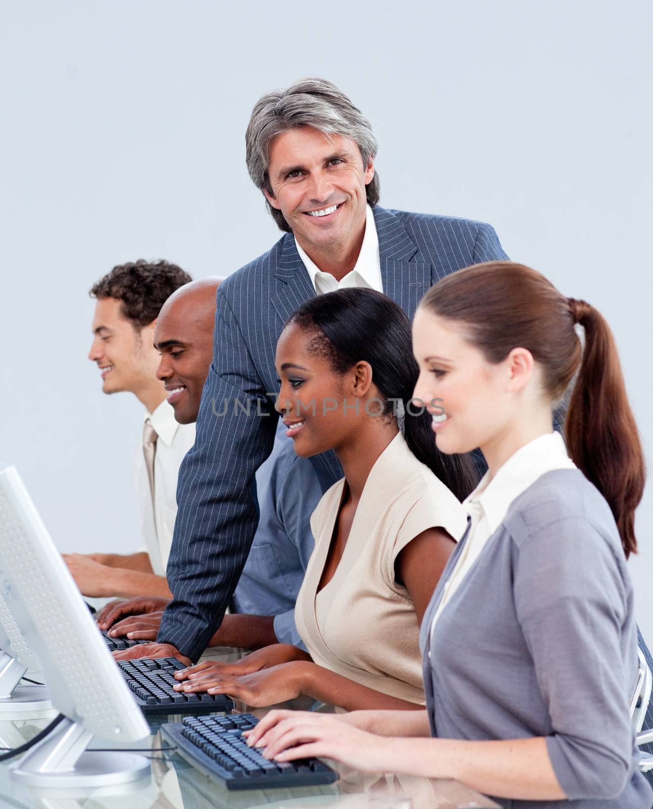 Mature manager checking his team's work in a call center