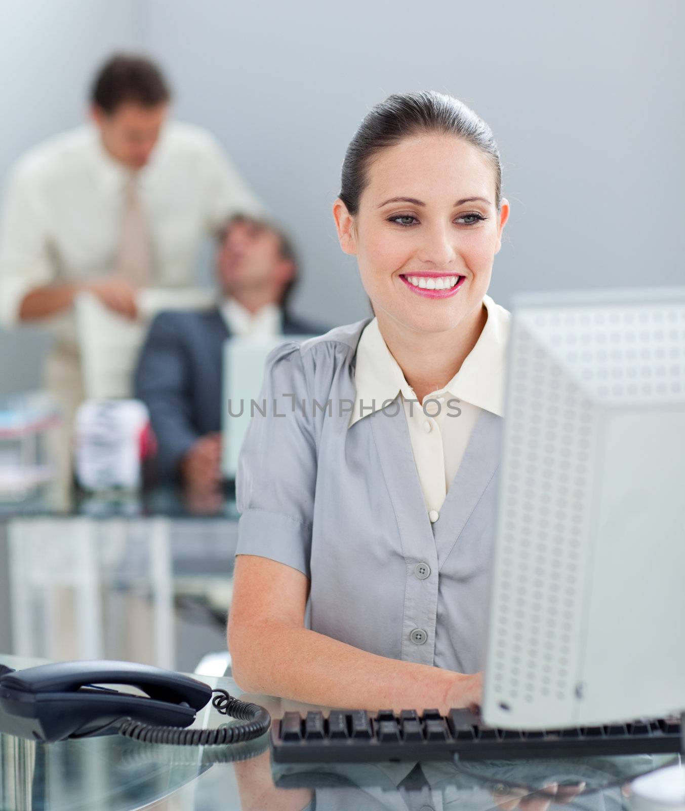 Radiant businesswoman working at a computer in the office