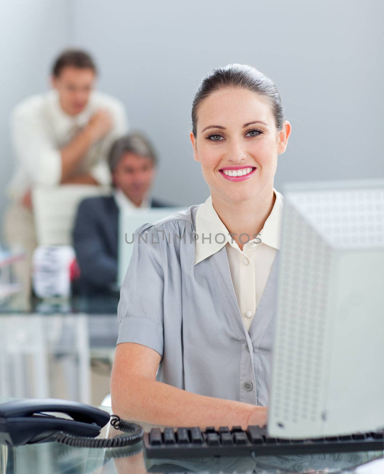Charming businesswoman working at a computer in the office