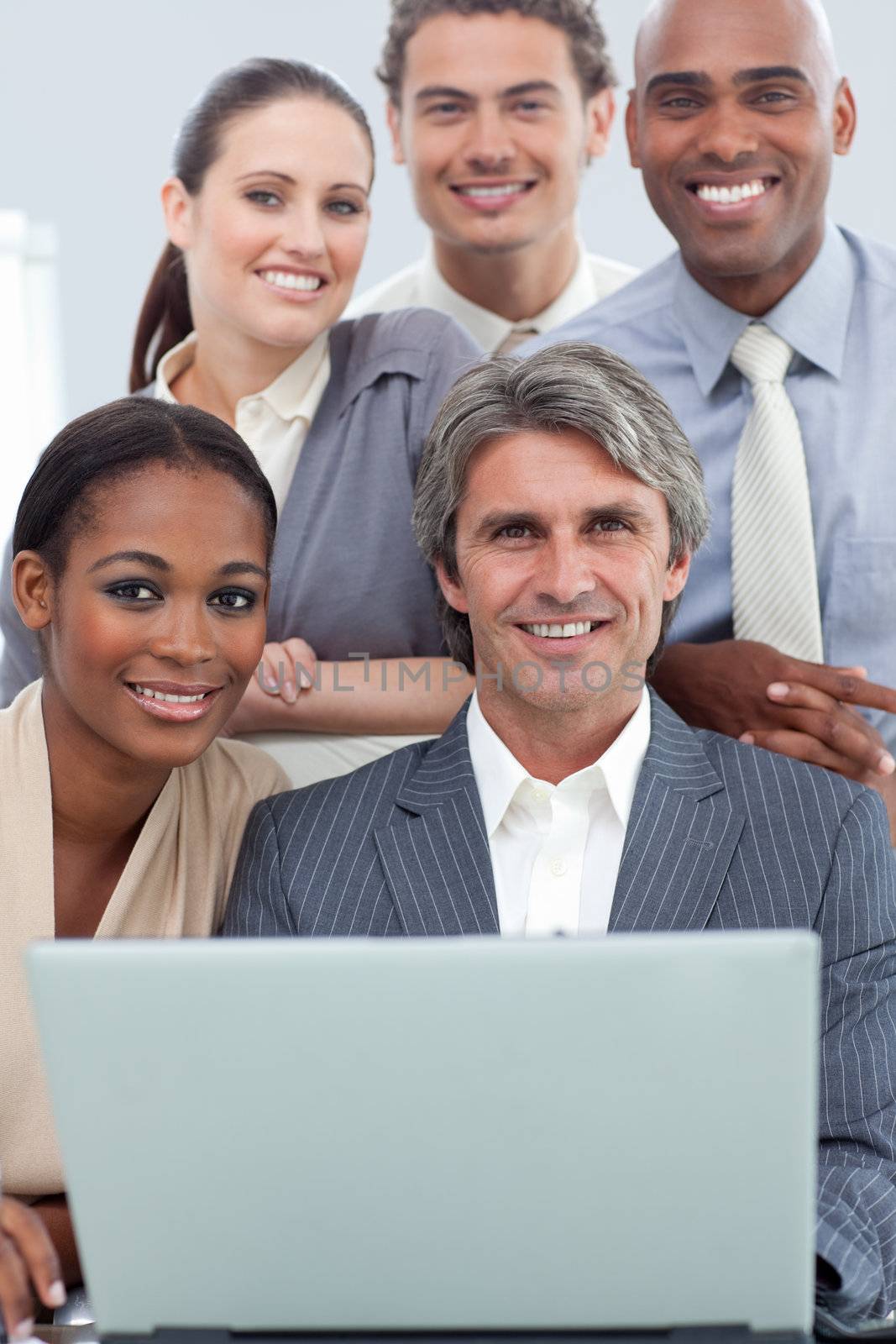A diverse business team working at a laptop in a meeting