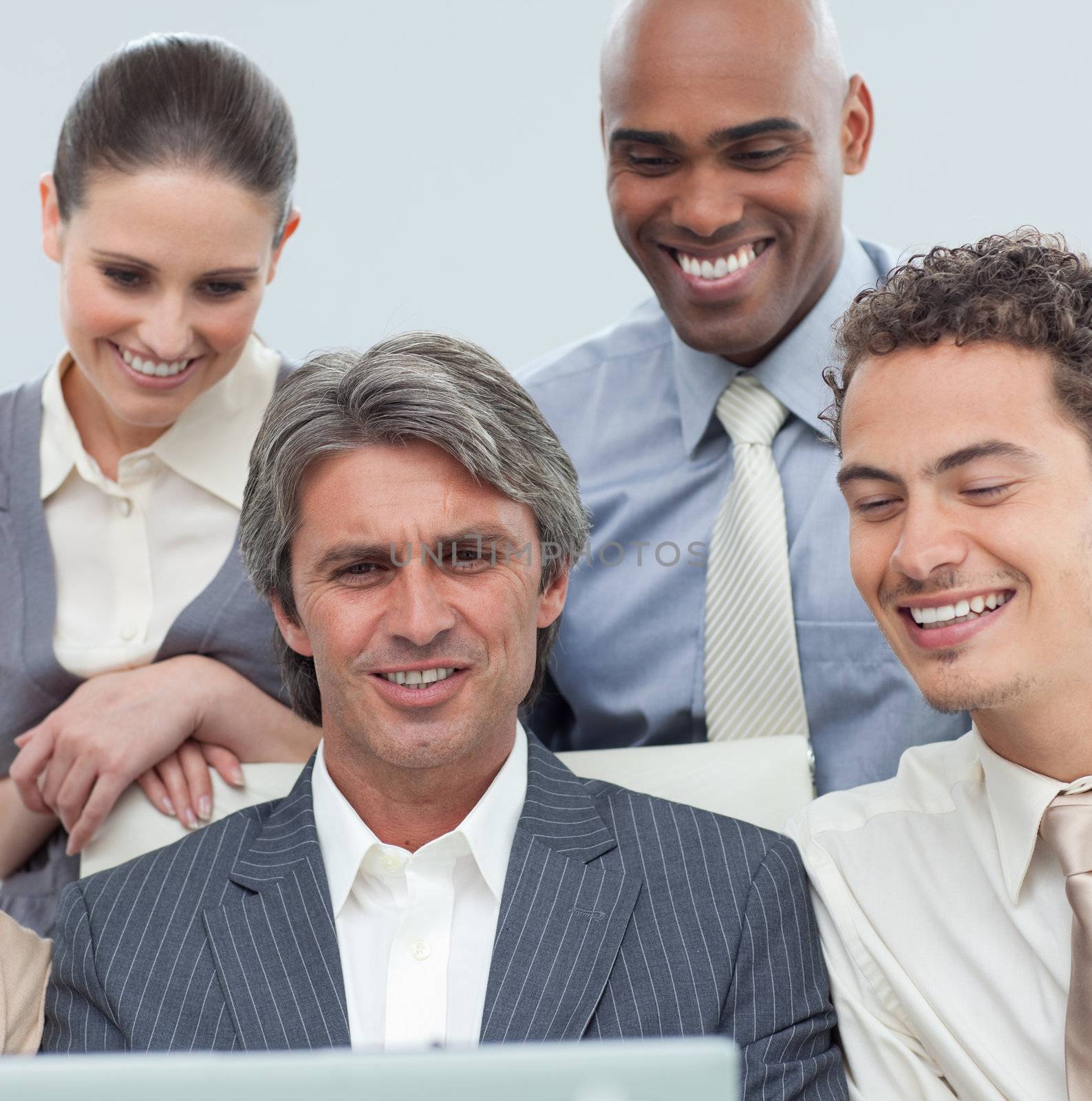 International business team working at a laptop in a meeting