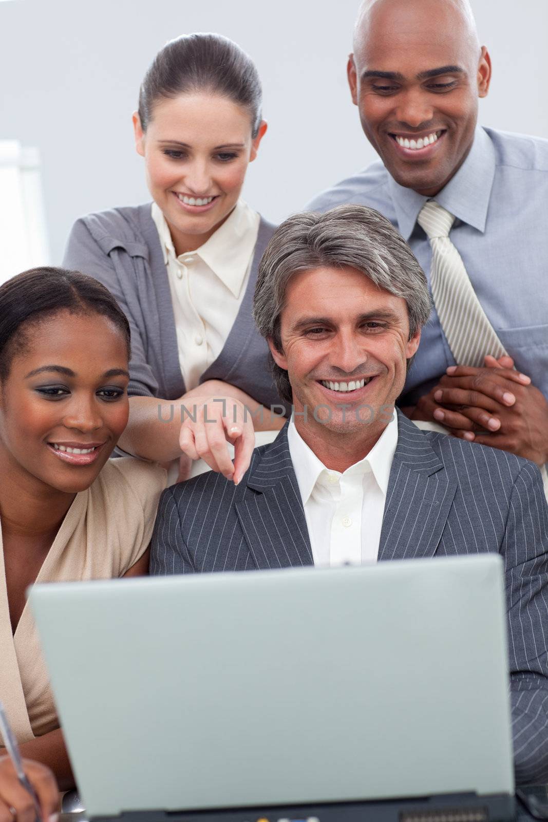 A business team showing ethnic diversity using a laptop in a meeting