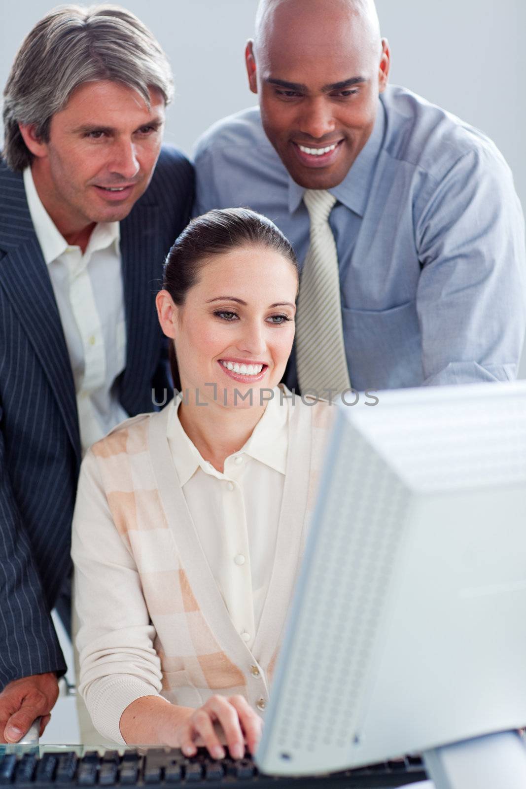 Assertive business people working at a computer in the office